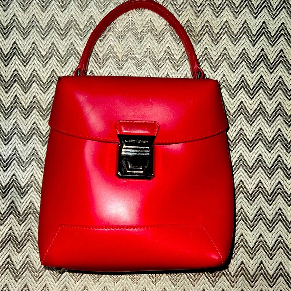 Red Lancaster tote chrome clasp and long adjustable red. strap